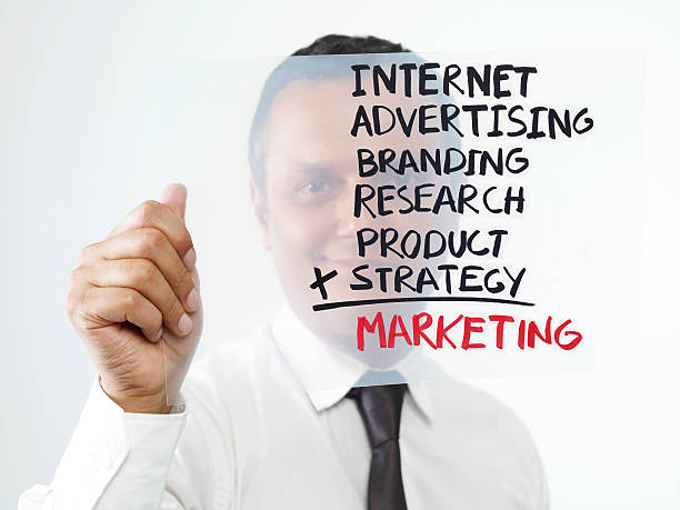 Marketing Businessman holding transparency sheet with marketing formula. man writing on white board stock pictures, royalty-free photos & images