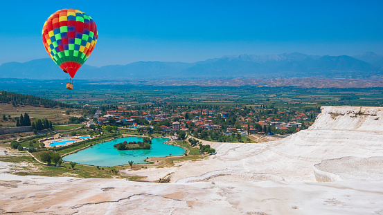 Hot air balloon above at Pammukale near modern city Denizli, Turkey. One of famous tourists place in Turkey.
