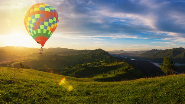 istock Hot air balloon above high mountain at sunset 1648170835