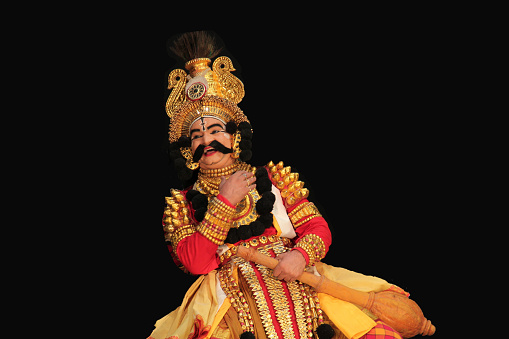 Senior Yakshagana artist showing  happiness popular dance form of south india