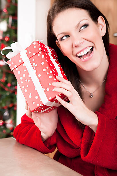 istock Smiling woman holding christmas present 164817272