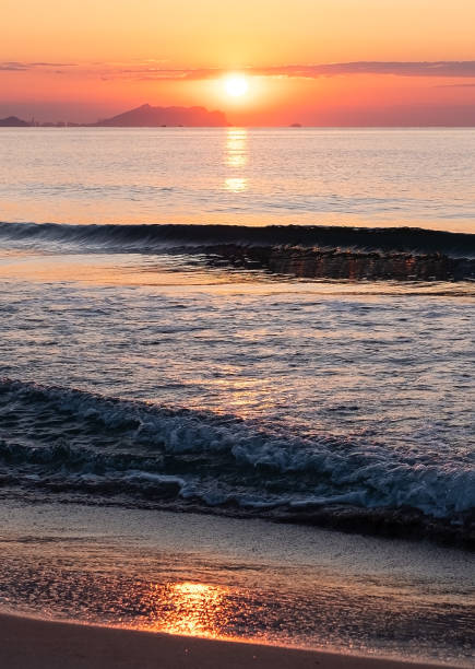 istock Bright orange sunrise over the sea. Tidal bore. 1648179186