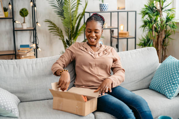 istock Young Woman Unboxing A Package She Ordered Online 1648187897