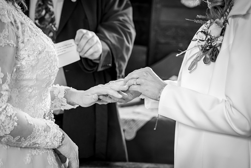 two brides exchanging rings in same sex ceremony