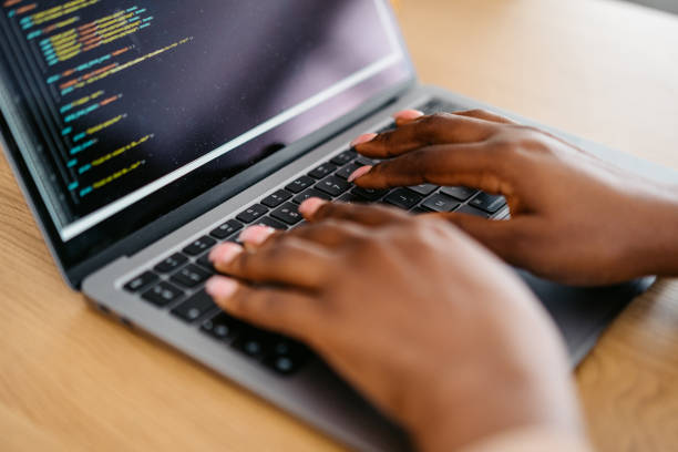 istock Young Woman Programming On A Laptop At Home 1648189492