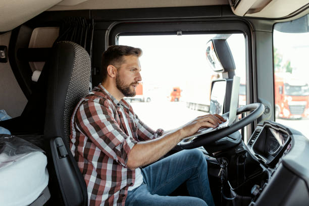 istock Male Truck Driver Checking Using Laptop 1648190180