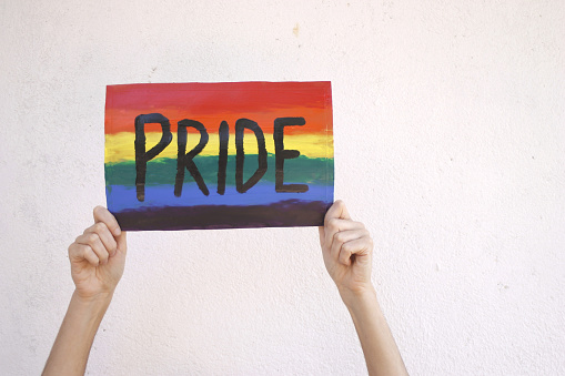 Rainbow Unity: Woman's Hands Embrace the Pride Poster