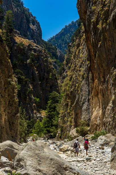 istock Hikers in a narrow, deep gorge on a hot summers day 1648191704