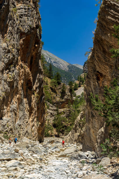 istock Hikers in a deep gorge surrounded by spectacular cliffs during a hot summer 1648191778