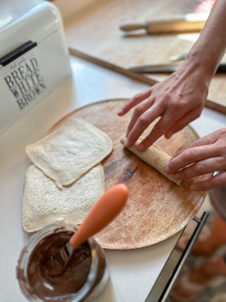 istock Hands preparing a simple chocolate sushi recipe 1648196924