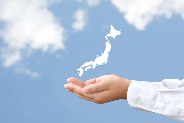 Child's hand Japan map oh blue sky background