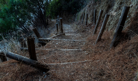 Wooden stairs leading path to Aegean sea beach in Greece at sunset