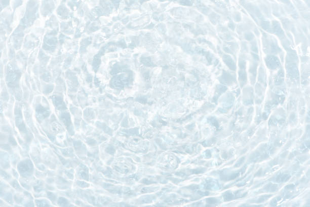 istock Blue water with ripples on the surface. Defocus blurred transparent blue colored clear calm water surface texture with splashes and bubbles. Water waves with shining pattern texture background. 1648217106