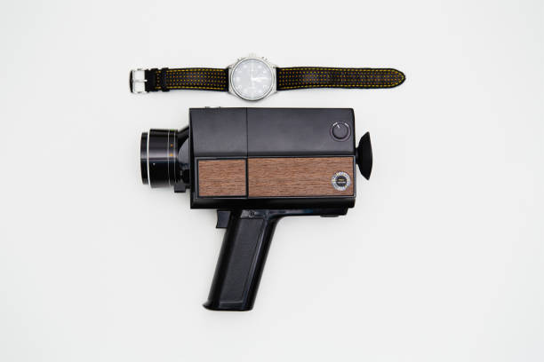 super8 analógico anticuado, cámara de cine de 8 mm y un reloj de pulsera sobre fondo blanco - 8mm camera fotografías e imágenes de stock