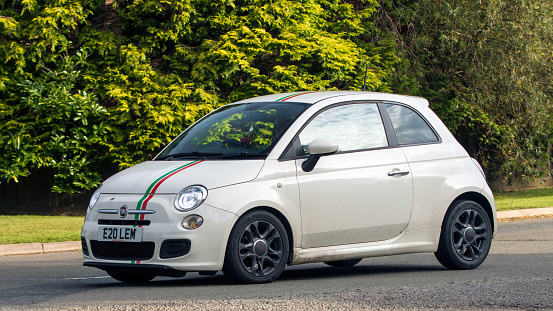Whittlebury,Northants,UK -Aug 27th 2023: 2014 white Fiat 500 S car travelling on an English country road