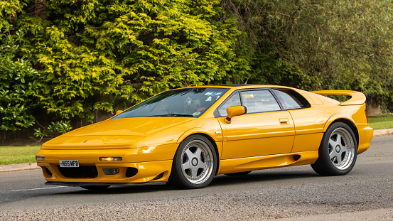 Whittlebury,Northants,UK -Aug 27th 2023:  1996 yellow Lotus Esprit V8 turbo  car travelling on an English country road