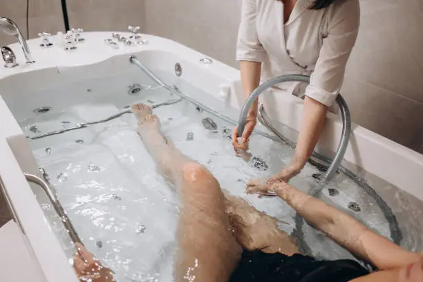 Young woman during hydromassage in beauty salon. High quality photo