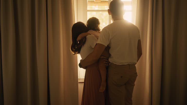 SLO MO Cute Girl With Parents Looking Through Window at Home