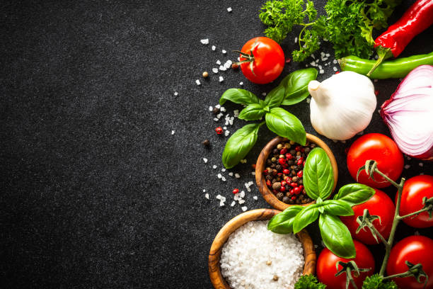 istock Food cooking background on black stone table. 1648264876