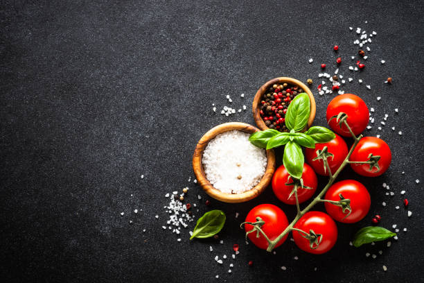 istock Food cooking background on black stone table. 1648265009