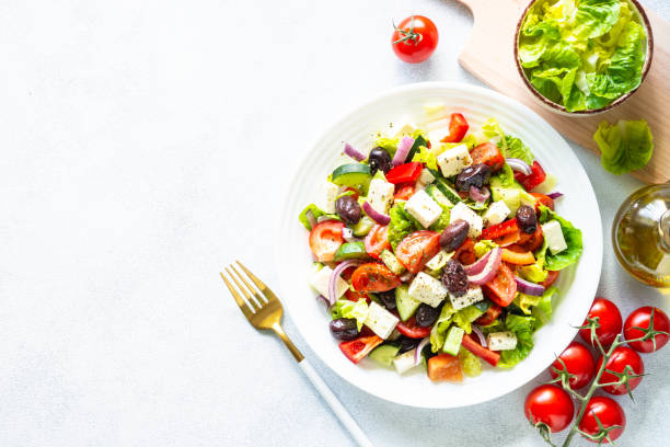 istock Greek salad with olives at white. 1648268193