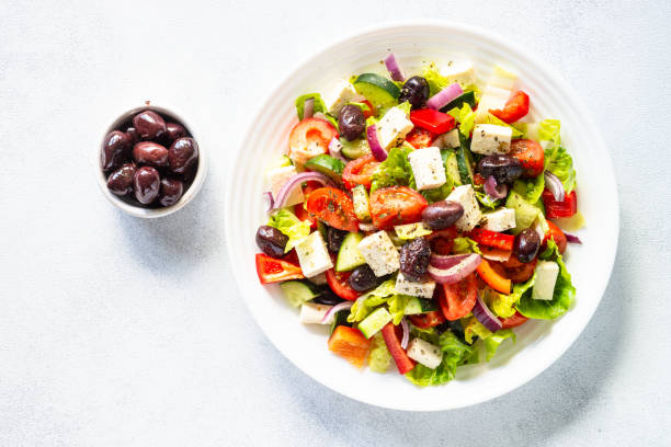 istock Greek salad with olives at white. 1648268427