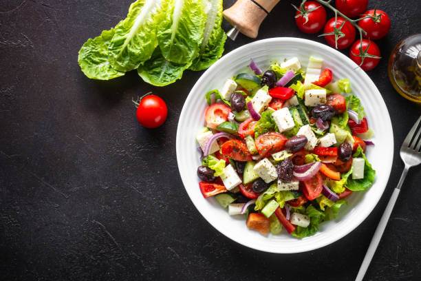 Greek salad with olives at black.
