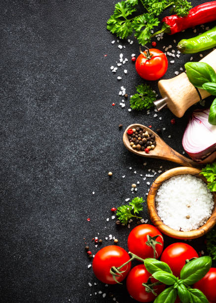 istock Food cooking background on black stone table. 1648270070