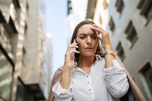 Angry businesswoman using phone shouting