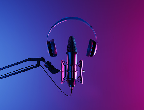 studio microphone with headphones on top and neon lighting with blue and pink gradient background. podcast, streaming and radio concept. 3d rendering