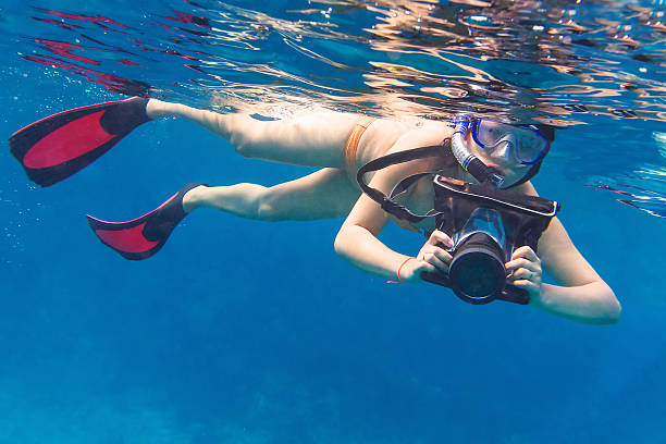istock Young women snorkeling with underwater camera 164830569