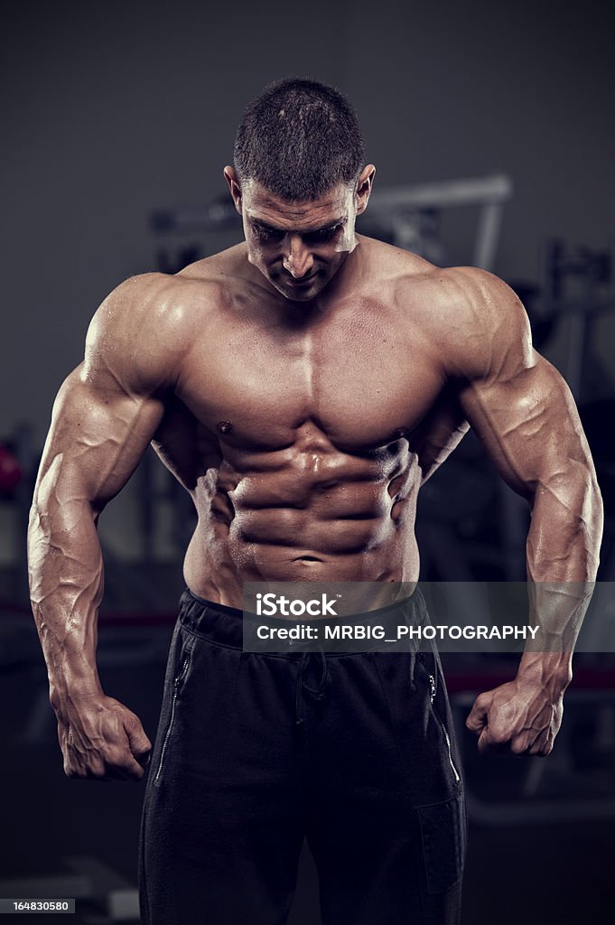 Hero Portrait of young handsome body builder. Abdominal Muscle Stock Photo