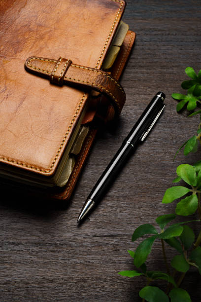 istock Ring bound planner and pen on wooden table 1648312448