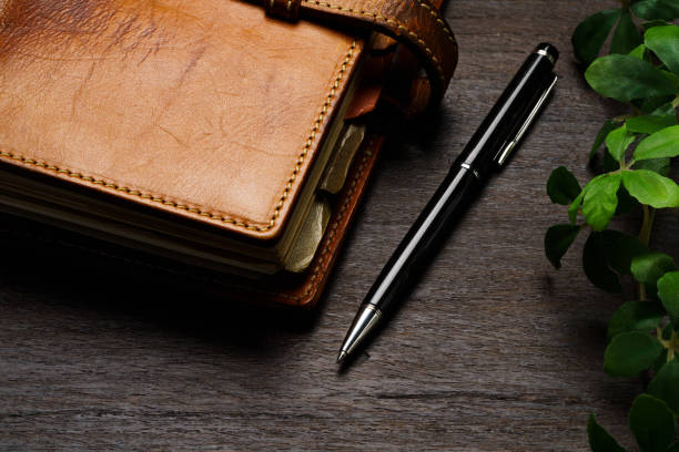 istock Ring bound planner and pen on wooden table 1648312983