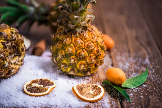 top view of fresh pineapple on textured sand with copy space