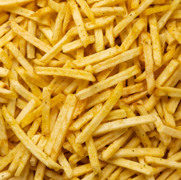 istock potato straws. potato background Macro. Falling potatoes, fries 1648317937