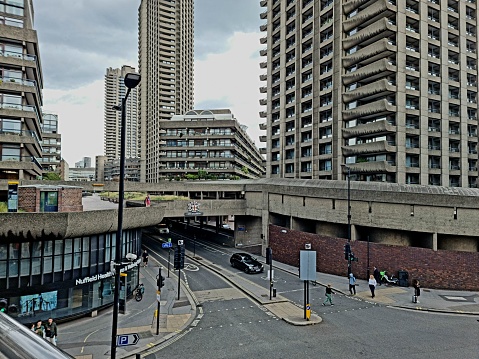 London with the Barbican Towers . The Barbican Estate, or Barbican, is a residential complex of around 2,000 flats, maisonettes, and houses in central London. The buildings where realized between 1965 and 1976 in brutalist architecture.