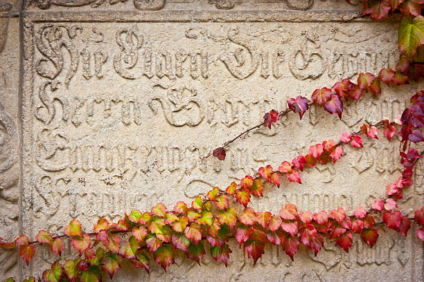 Tombstone partially covered by ivy, Bressanone, Trentino Alto Adige, Italy