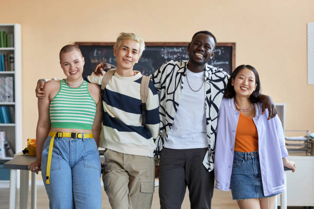 Team of cheerful friendly learners of highschool looking at camera