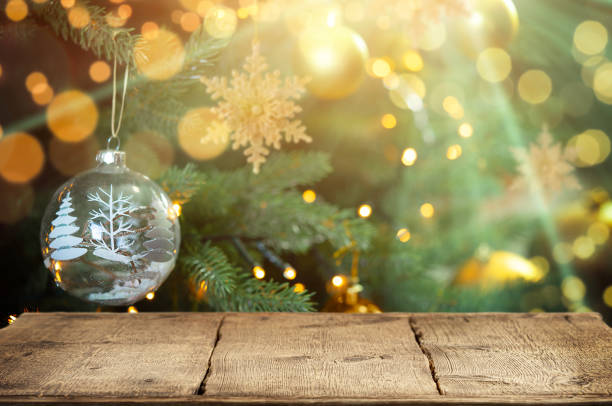 istock Wooden table on sparkling Christmas tree background. Copy space. 1648344931