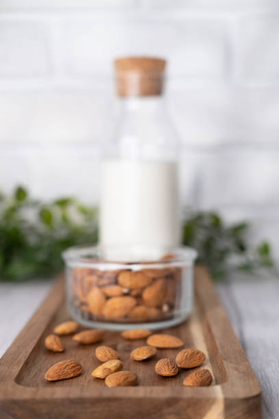istock Almond milk in a glass bottle in white kitchen. 1648365807