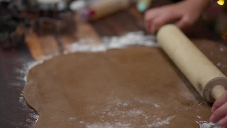 Teenage Girls Trying to Prepare Christmas Cookies in Domestic Kitchen