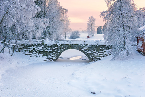 An old stone bridge in the countryside at wintertime. Winter sunset in Rusko, Finland.