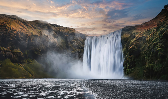 Waterfall and mountain in Winter Season. beautiful skogafoss waterfall in Iceland. Magnificent Skogafoss waterfall in Iceland in winter with dramatic sky