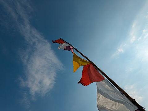 Colorful flags on a blue sky background