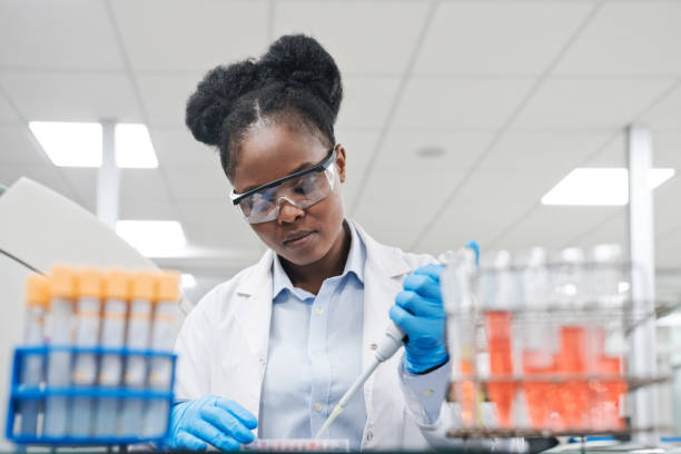 実験室で働きながらピペットで化学物質を充填する若い女性科学者 - laboratory equipment technician laboratory chemist ストックフォトと画像