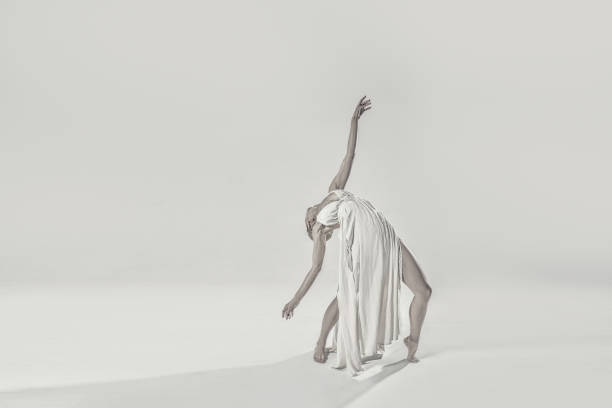 istock Ballerina in maxi dress dancing over light studio background. Ballet Dancer. Modern Dance. Graceful Woman. Hobby. 1648464886