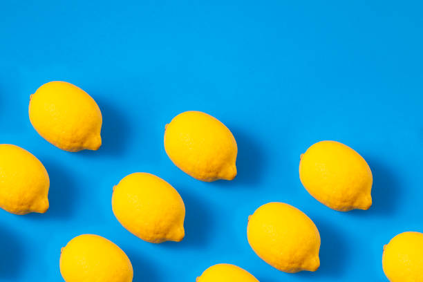 Lemons in a row on blue background
