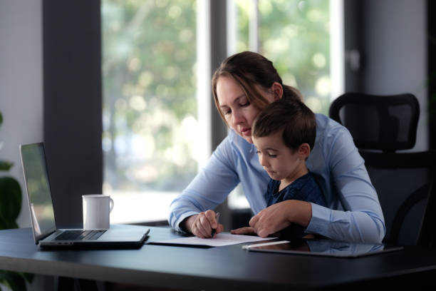 istock Mother working from home devotes some time to her little son 1648479429