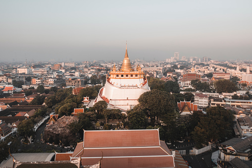 Sunrising behind the Golden Mount Temple with the Bangkok Skyline in background